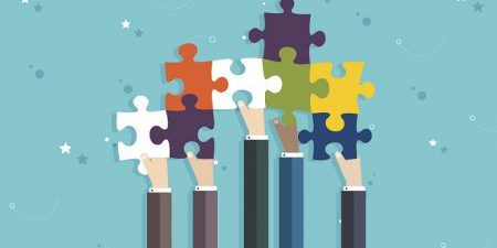 Concept of teamwork and integration with businessman holding colorful puzzle